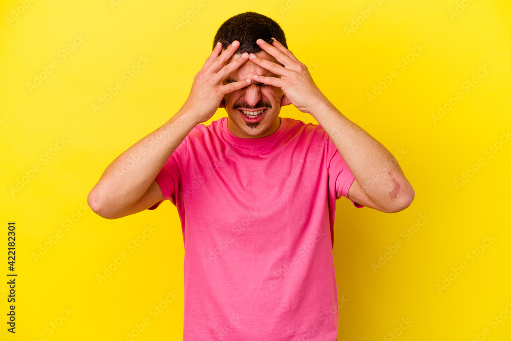 Young caucasian cool man isolated on yellow background having a head ache, touching front of the face. Young caucasian cool man isolated on yellow background having a head ache, touching front of the face.
