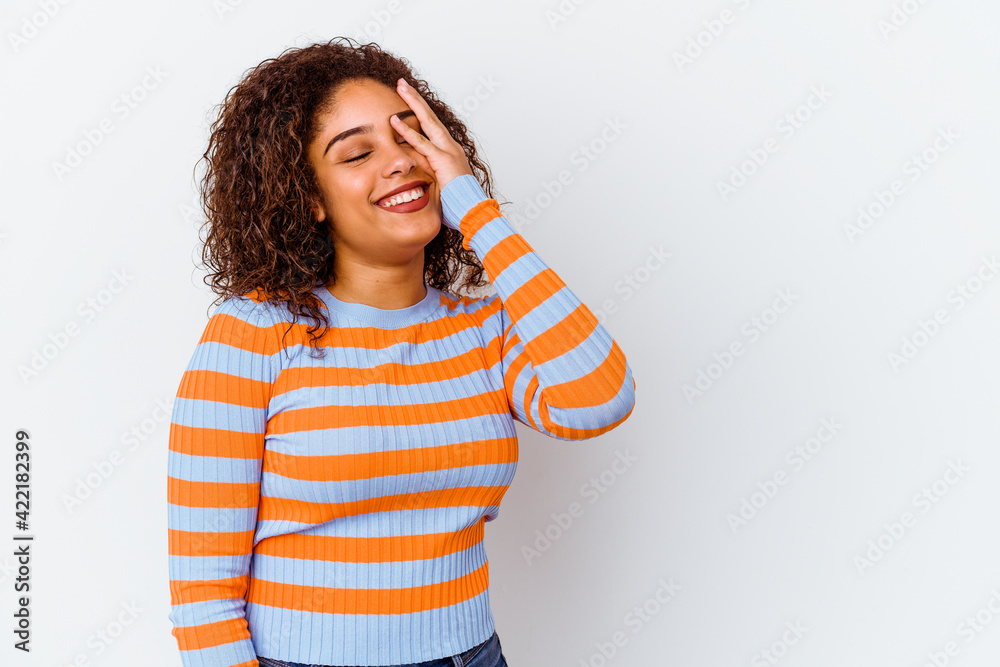 Young african american woman isolated on white background laughing happy, carefree, natural emotion.