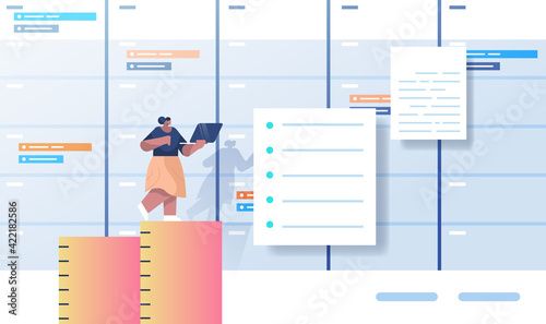 african american businesswoman working on laptop business planning multitasking time management concept