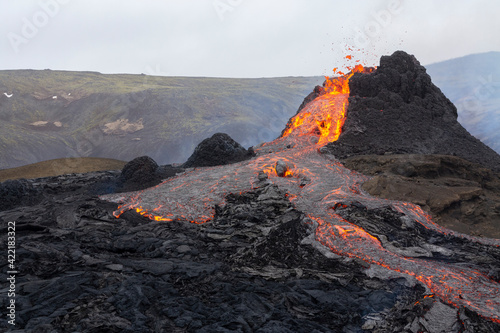 GELDINGADALIR, ICELAND - MARCH 21, 2021: A small volcanic eruption started at the Reykjanes peninsula. The event has attracted thousands of visitors who have braved a daring hike to the crater.