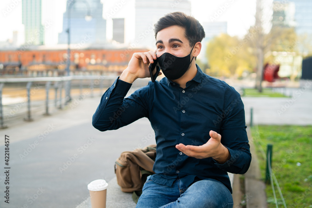 Young man talking on the phone outdoors. Young man talking on the phone outdoors.