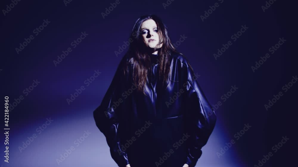Dark and long hair woman posing in the studio. Young attractive model girl wearing black dress dancing in the studio. Dark and long hair woman posing in the studio. Young attractive model girl wearing black dress dancing in the studio.