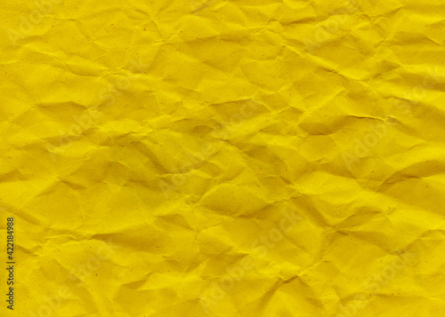 Yellow Crumpled Paper Background. Yellow rustic texture. High quality texture in extremely high resolution. Dark yellow grunge material. Texture background. Scrapbook