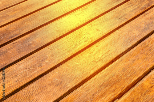 Diagonal wood surface texture with sunlight brown planks table background