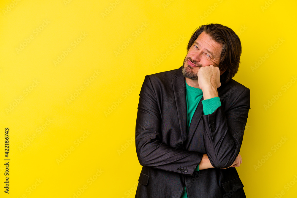 Middle age caucasian man isolated on yellow background who feels sad and pensive, looking at copy space. Middle age caucasian man isolated on yellow background who feels sad and pensive, looking at copy space.