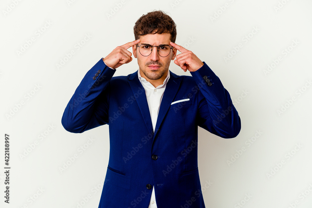 Young business caucasian man isolated on white background focused on a task, keeping forefingers pointing head. Young business caucasian man isolated on white background focused on a task, keeping forefingers pointing head.