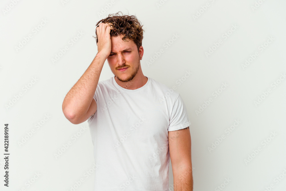 Young caucasian man isolated on white background forgetting something, slapping forehead with palm and closing eyes.