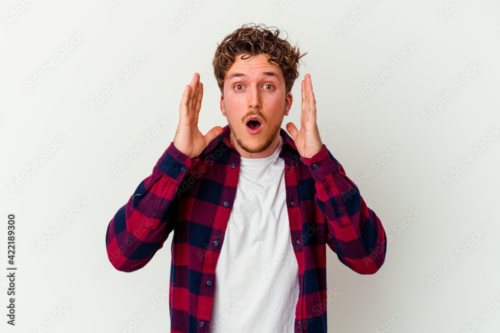 Young caucasian man isolated on white background surprised and shocked. Young caucasian man isolated on white background surprised and shocked.