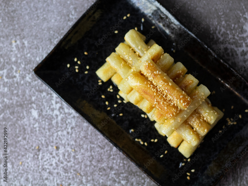 Korean Rice Cakes with Honey (Garaetteok). Dripping honey on tteokbokki
