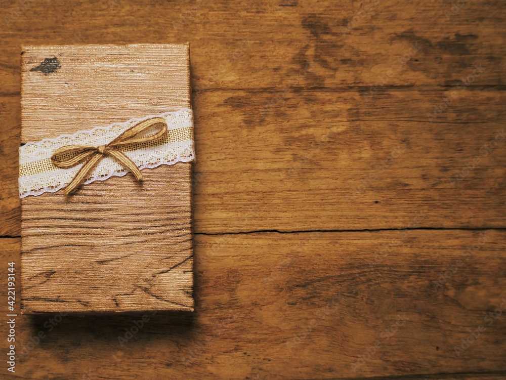 Fototapeta premium A gift box placed on an old wood.