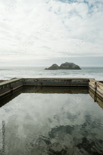 View of ocean with reflection of water and rocks