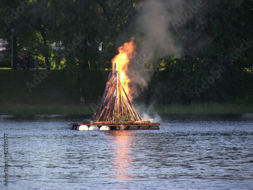 Canvas Print midsummer pyre on the lake