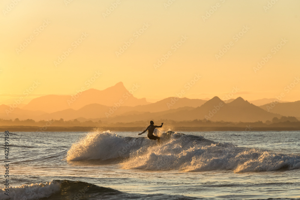 Surfing  at sunset, Byron Bay Australia