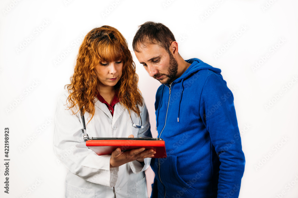 female doctor looking at results on a tablet with a patient female doctor looking at results on a tablet with a patient