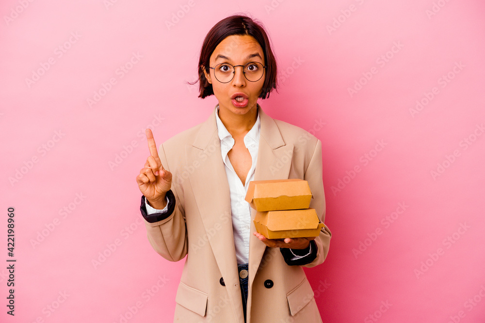 Young business mixed race woman isolated on pink background having some great idea, concept of creativity. Young business mixed race woman isolated on pink background having some great idea, concept of creativity.