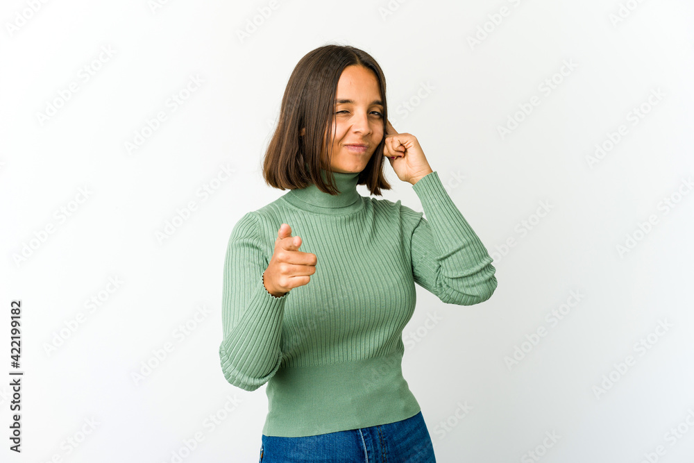 Young mixed race woman pointing temple with finger, thinking, focused on a task.