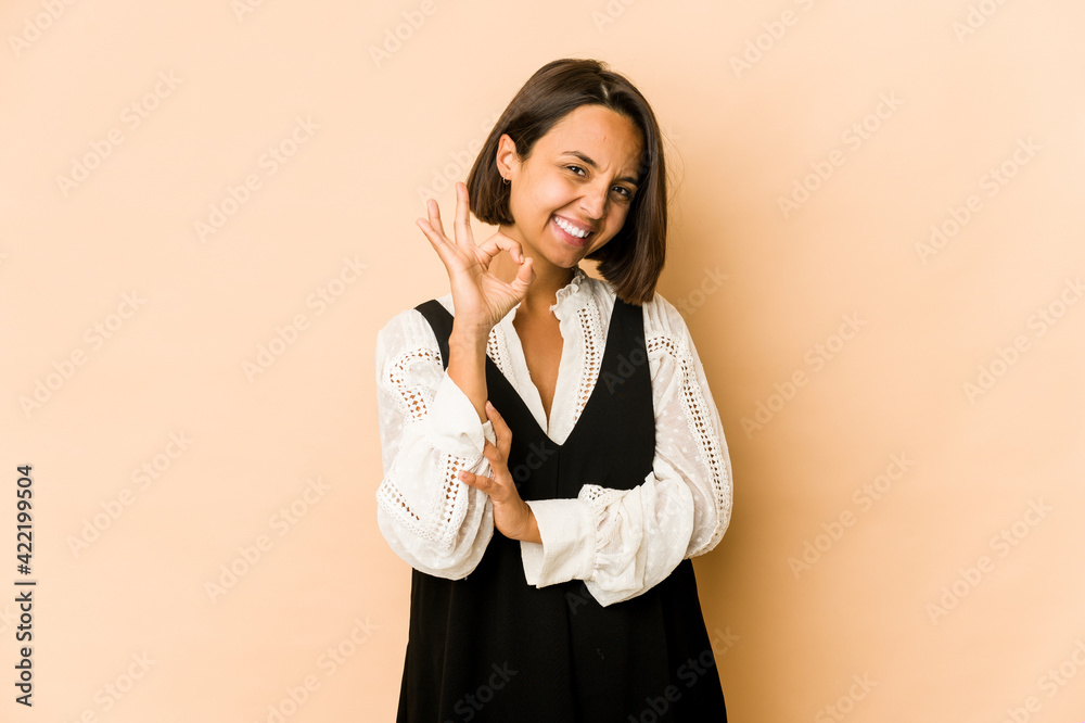 Young hispanic woman isolated cheerful and confident showing ok gesture.