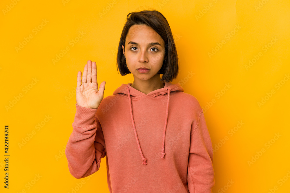 Young hispanic woman isolated on yellow smiling cheerful showing number five with fingers. Young hispanic woman isolated on yellow smiling cheerful showing number five with fingers.