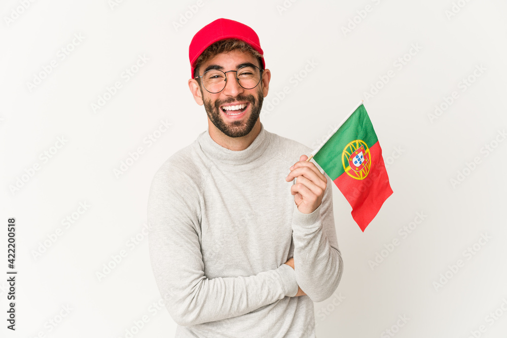 Young hispanic mixed race woman holding a portugal flag laughing and having fun. Young hispanic mixed race woman holding a portugal flag laughing and having fun.