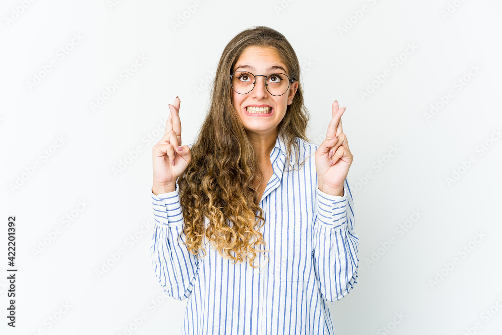 Young caucasian woman crossing fingers for having luck Young caucasian woman crossing fingers for having luck
