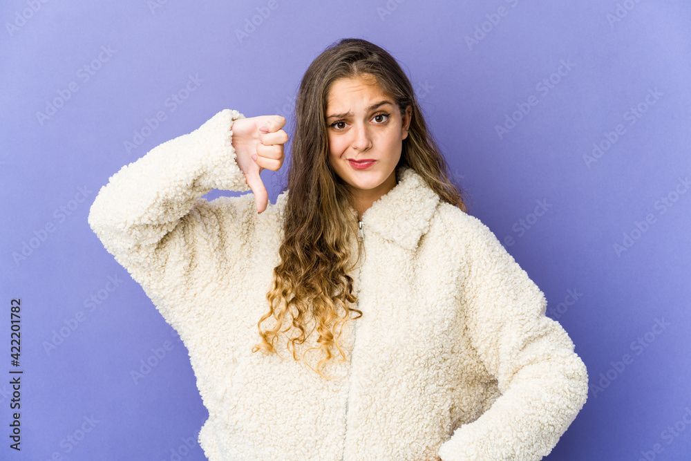 Young caucasian cute woman showing thumb down, disappointment concept. Young caucasian cute woman showing thumb down, disappointment concept.