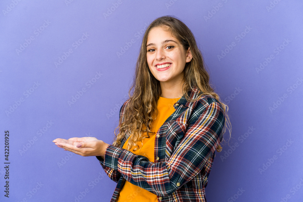 Young caucasian cute woman holding a copy space on a palm. Young caucasian cute woman holding a copy space on a palm.