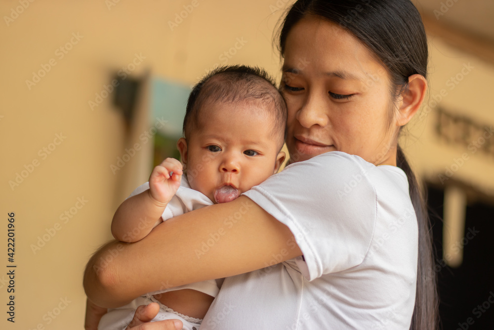 Young Asian mother holding little daughter in the park, Mother play enjoying with her cute baby girl in outdoor, copy space Young Asian mother holding little daughter in the park, Mother play enjoying with her cute baby girl in outdoor, copy space