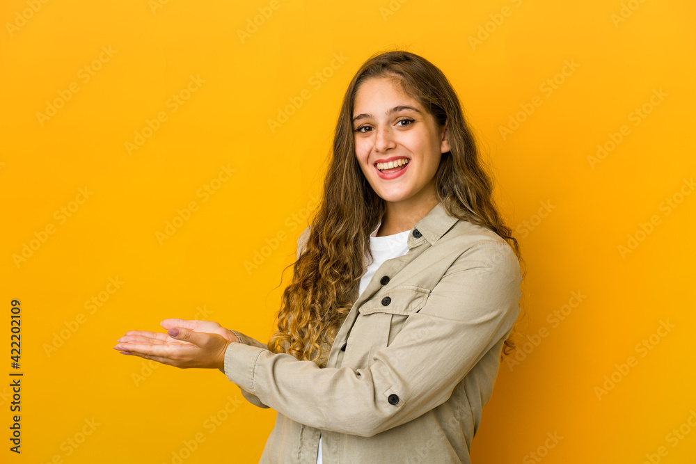 Young caucasian woman holding a copy space on a palm. Young caucasian woman holding a copy space on a palm.