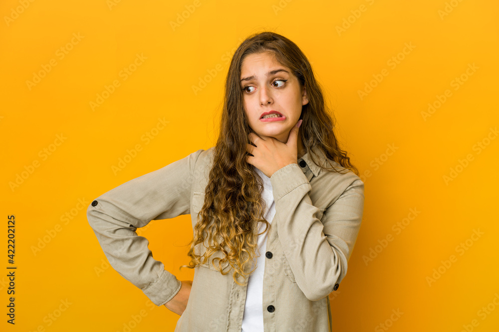 Young caucasian woman touching back of head, thinking and making a choice. Young caucasian woman touching back of head, thinking and making a choice.