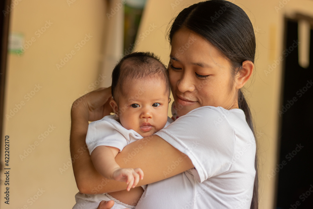 Young Asian mother holding little daughter in the park, Mother play enjoying with her cute baby girl in outdoor, copy space Young Asian mother holding little daughter in the park, Mother play enjoying with her cute baby girl in outdoor, copy space