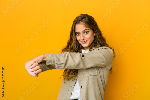 Young caucasian woman stretching arms, relaxed position. © Asier