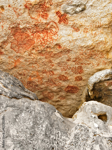 Carib or Arawak cave paintings in red dye on a rock wall, pre_Columbian art in the Antilles. photo