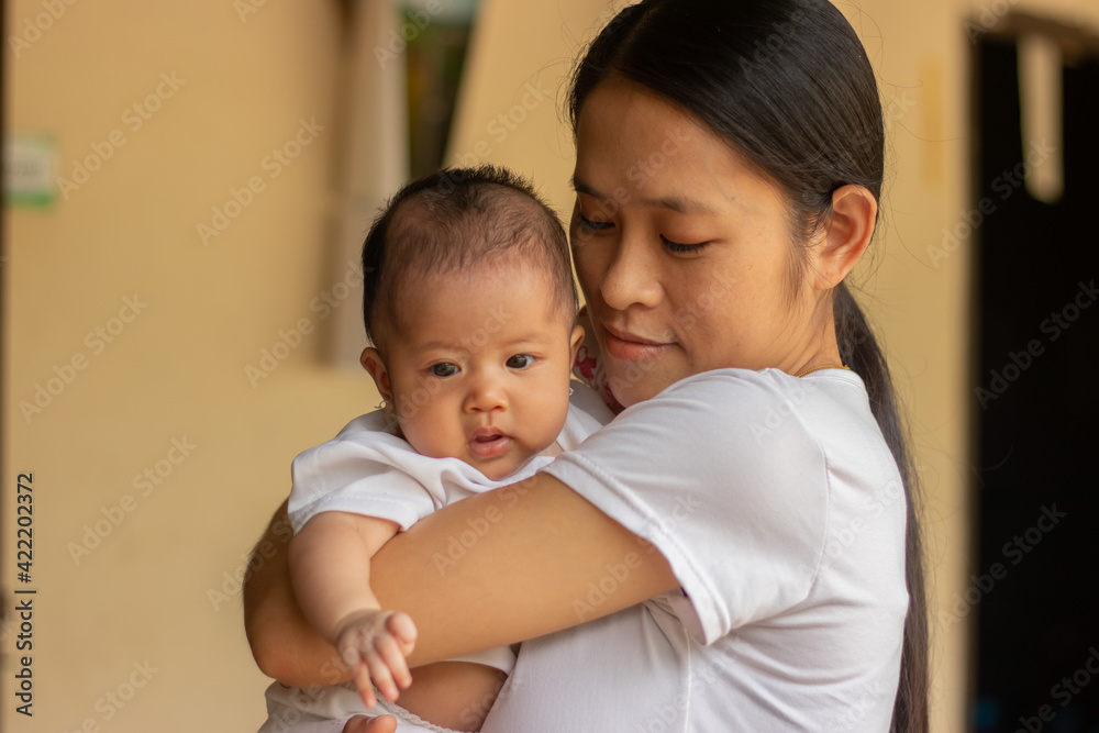 Young Asian mother holding little daughter in the park, Mother play enjoying with her cute baby girl in outdoor, copy space Young Asian mother holding little daughter in the park, Mother play enjoying with her cute baby girl in outdoor, copy space