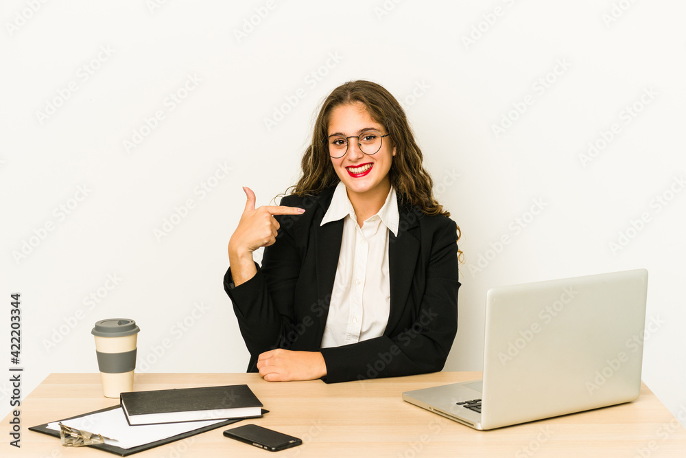 Young caucasian business woman working on her desktop isolated person pointing by hand to a shirt copy space, proud and confident Young caucasian business woman working on her desktop isolated person pointing by hand to a shirt copy space, proud and confident