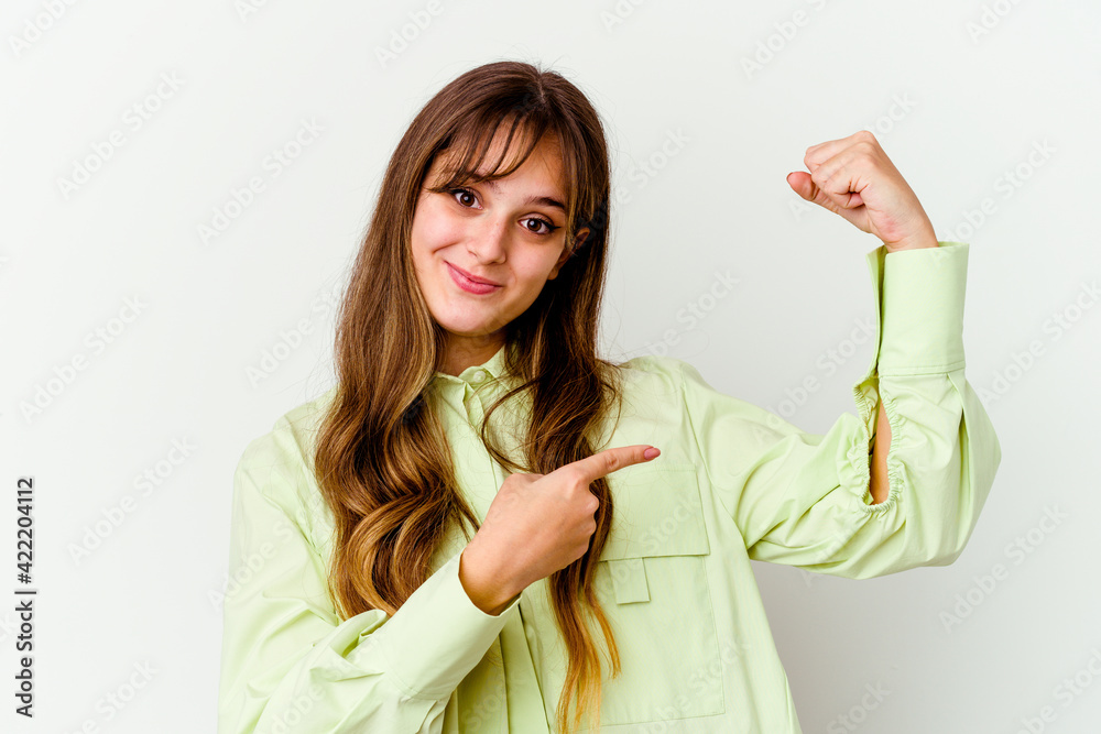 Young caucasian cute woman isolated on white background showing strength gesture with arms, symbol of feminine power Young caucasian cute woman isolated on white background showing strength gesture with arms, symbol of feminine power