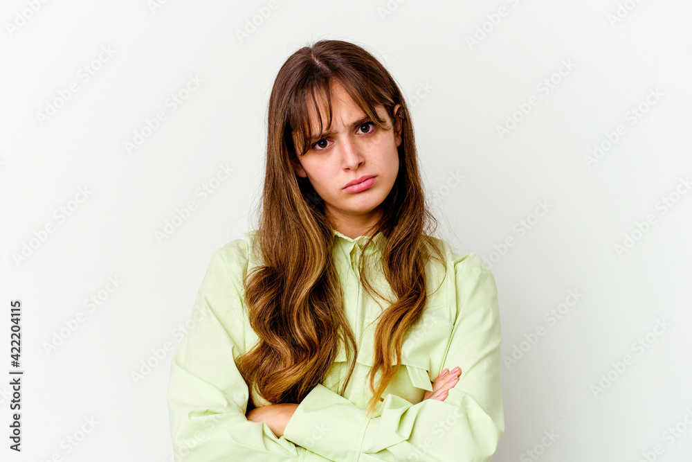 Young caucasian cute woman isolated on white background blows cheeks, has tired expression. Facial expression concept.