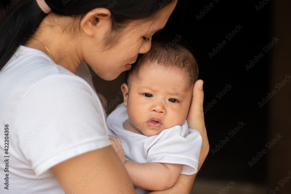 Young Asian mother kissing and holding little daughter in the park, Mother play enjoying with her cute baby girl in outdoor, copy space
Young Asian mother kissing and holding little daughter in the park, Mother play enjoying with her cute baby girl in outdoor, copy space
