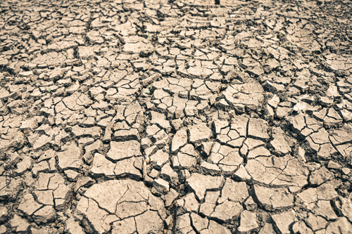 Landscape ground cracks drought crisis environment background.