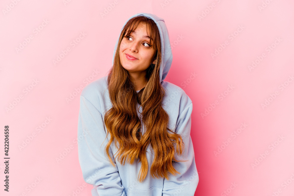 Young caucasian woman with hood isolated on yellow background dreaming of achieving goals and purposes Young caucasian woman with hood isolated on yellow background dreaming of achieving goals and purposes