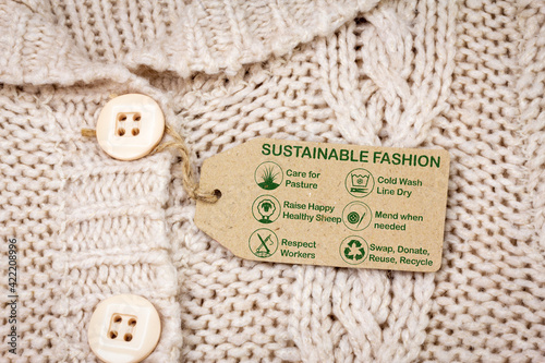 sustainable fashion label on woollen jumper with care icons and text, ethical consumerism
