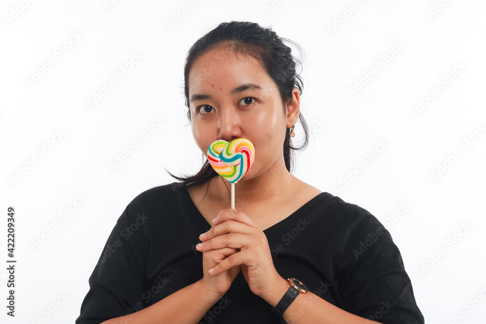 Fashion portrait young woman and lollipop is having fun over white background. Fashion portrait young woman and lollipop is having fun over white background.