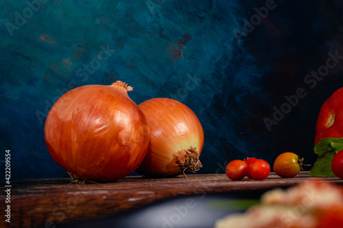 onion tomato basil tomato bread on wooden base and dark background