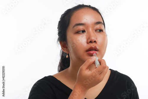 Beautiful woman holding cosmetic product.