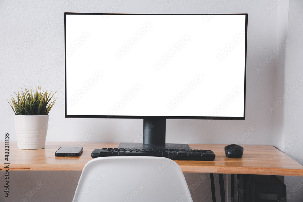 Computer monitor with white blank screen on the business desk with wireless mouse, keyboard at home office over white wall background, Photo of equipment contemporary workspace Computer monitor with white blank screen on the business desk with wireless mouse, keyboard at home office over white wall background, Photo of equipment contemporary workspace