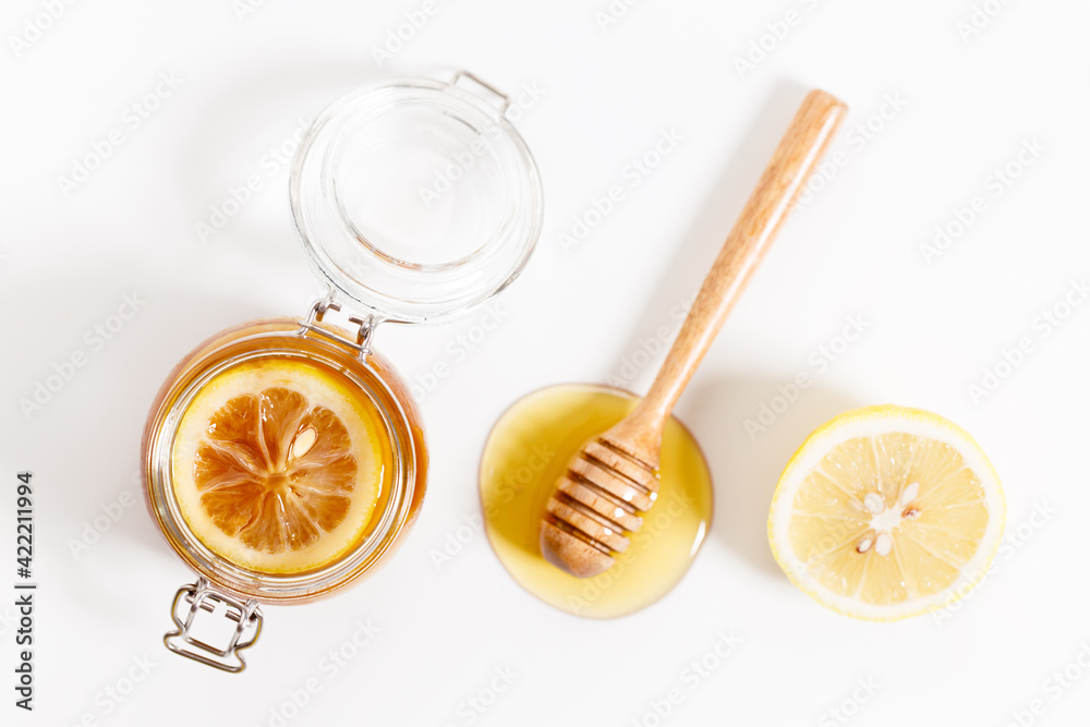 Lemon and honey on white stone background