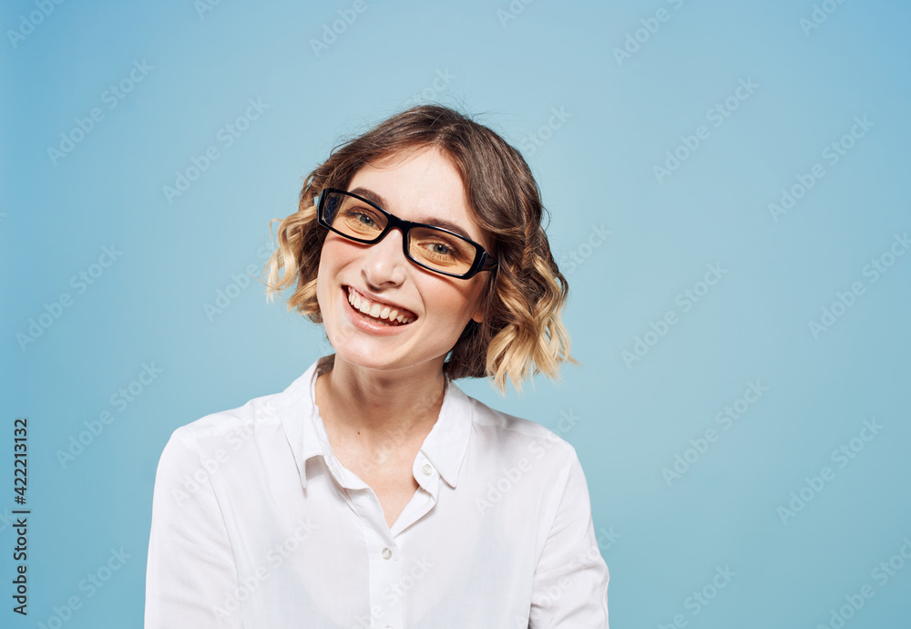 Cute model in a white shirt girl on a blue background cropped view close-up Cute model in a white shirt girl on a blue background cropped view close-up