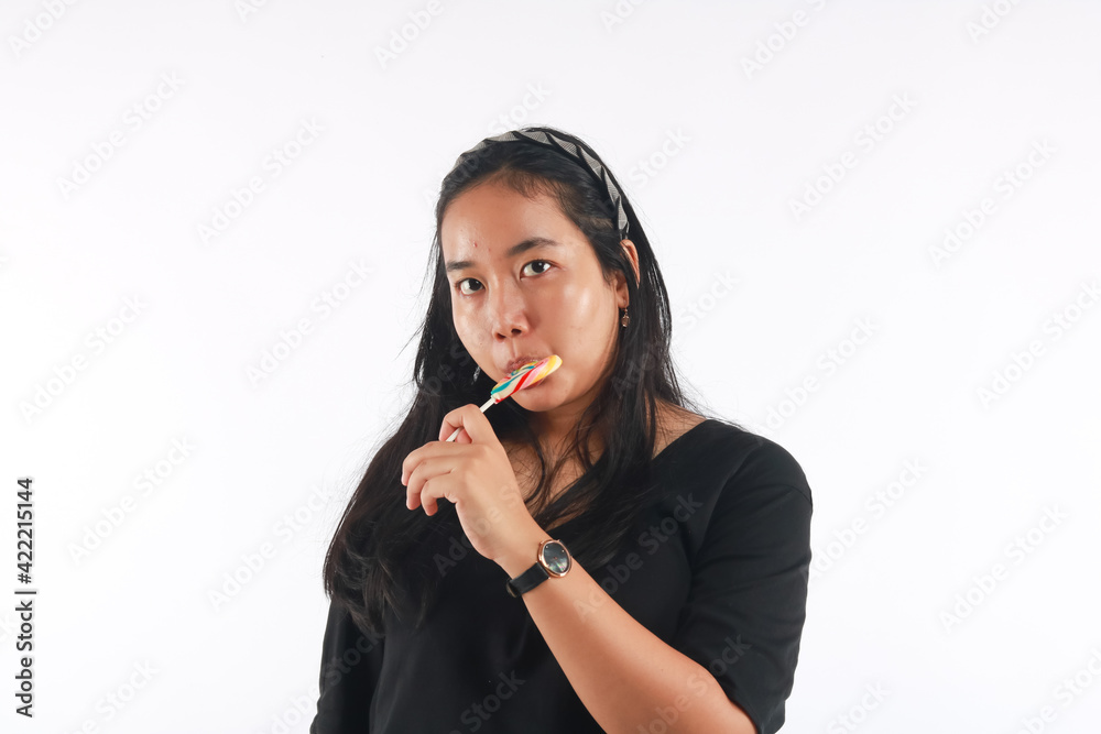 Fashion portrait young woman and lollipop is having fun over white background. Fashion portrait young woman and lollipop is having fun over white background.