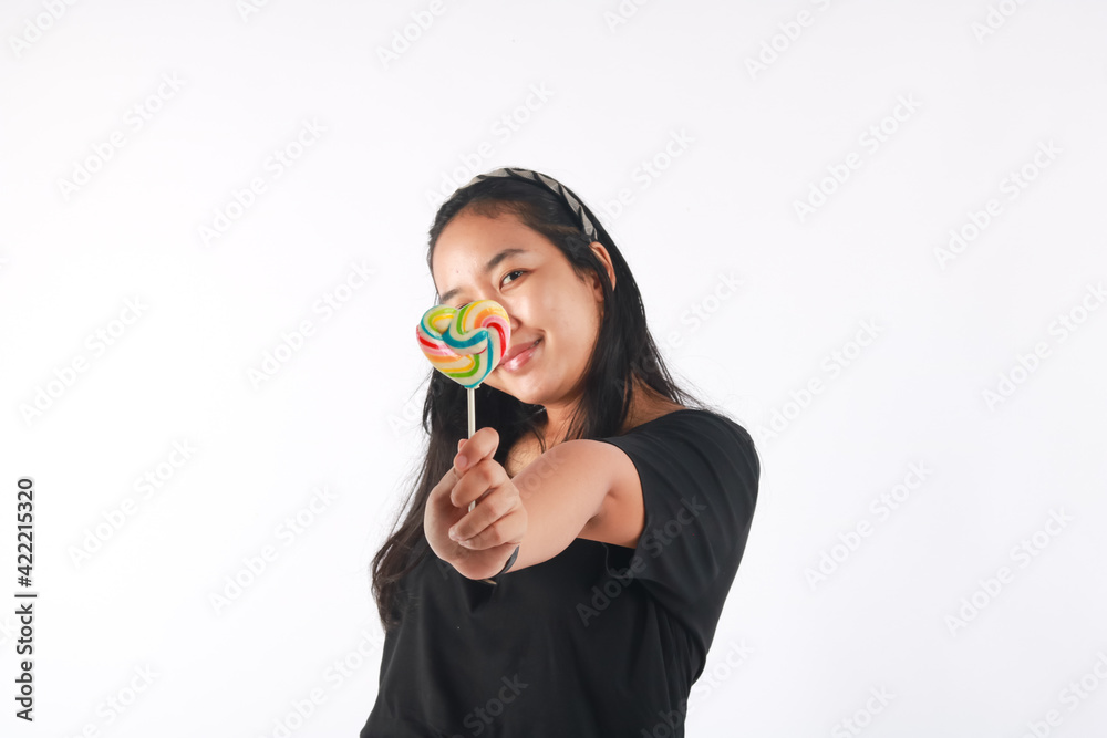 Fashion portrait young woman and lollipop is having fun over white background. Fashion portrait young woman and lollipop is having fun over white background.