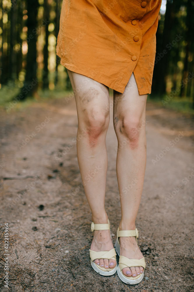 Cropped shot of slim woman's legs in the forest