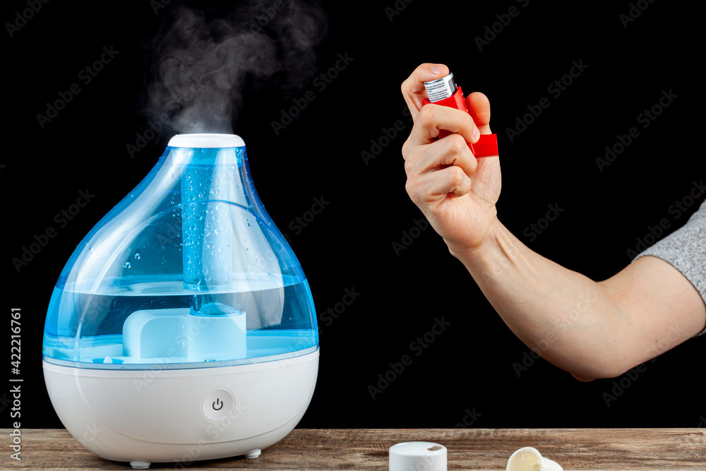Asthma, allergy attack concept with ultrasonic air humidifier creating